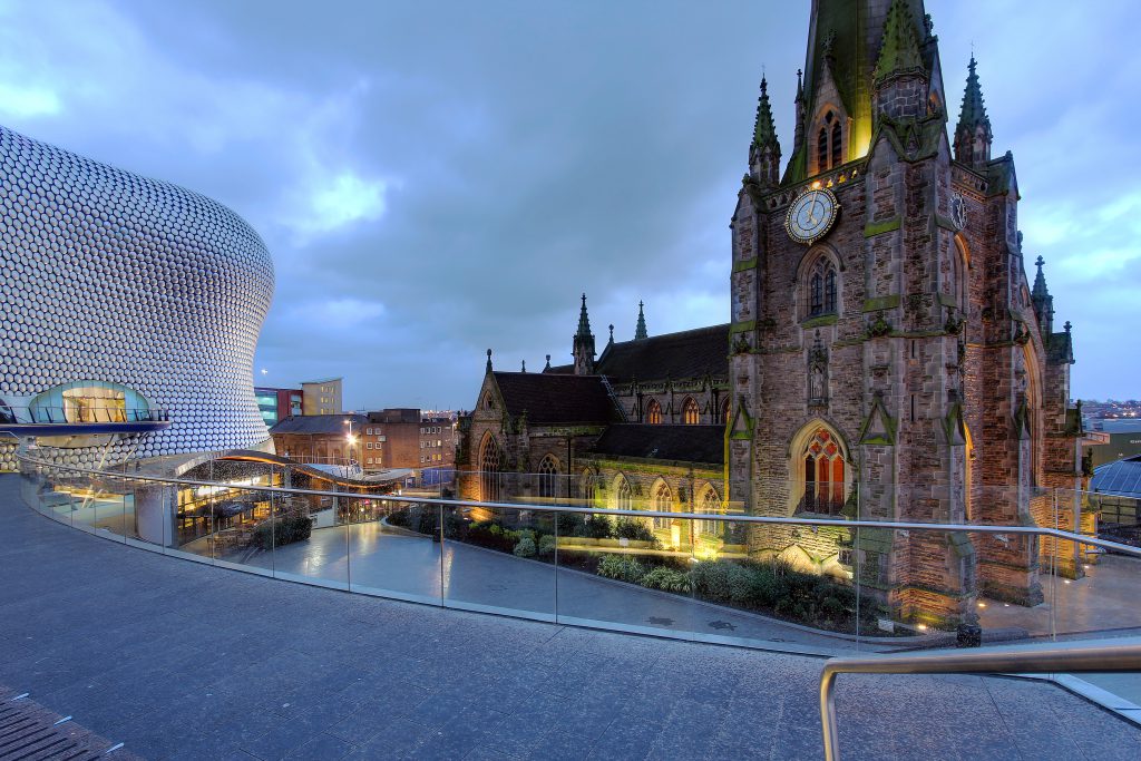 Night scene in downtown Birmingham with the parish church St. George in the Bullring and the Selfridges Department Store.