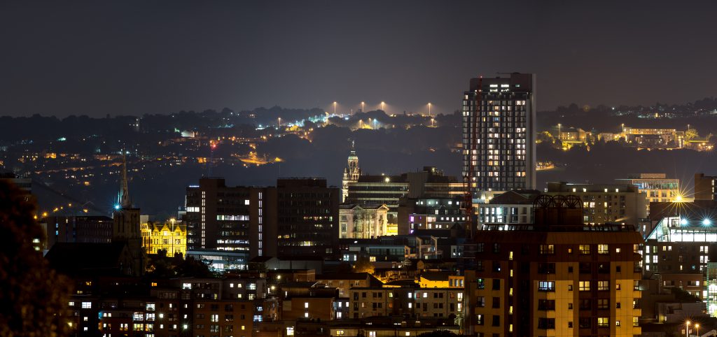 Sheffield city buildings with dramatic hill background